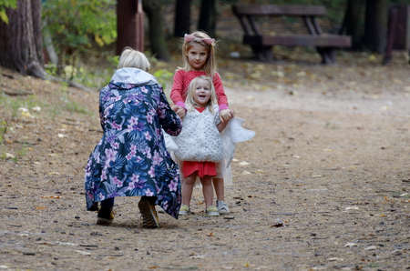 Mother photographing her little girls