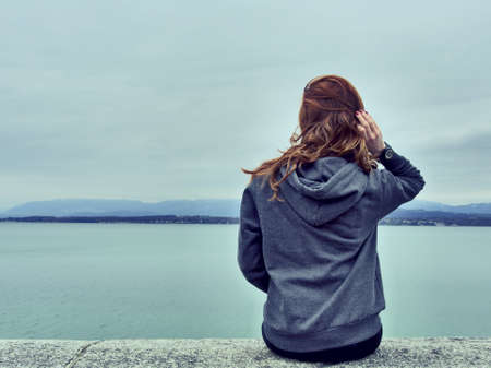 girl, woman, looking, brunette, long hair, hoodie, lake, water, view, sky, mountains, people