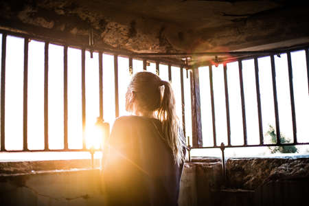 woman, girl, lady, people, back, contemplate, stand, grasp, steel, bars, concrete, room, confined,...
