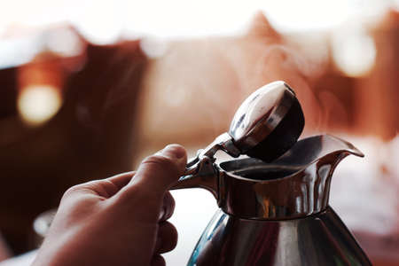 person, people, hand, hold, coffee, pot, kettle, open, smoke, silver, reflection, still, bokeh