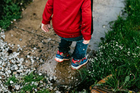 people, child, splash, rain, grass, rocks, jump