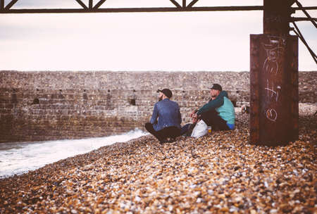 people, rest, stones, bridge, steel, building, wall, coast, picnic, sea, water