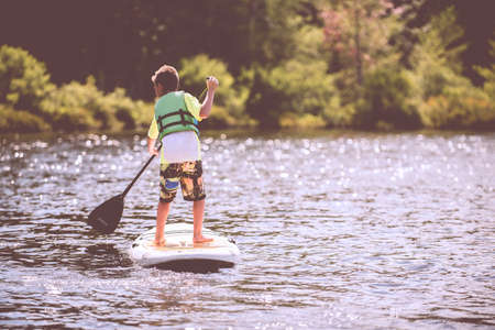 people, kid, child, boy, sailing, paddle, board, lake, water, sunshine, nature, trees, adventure,...