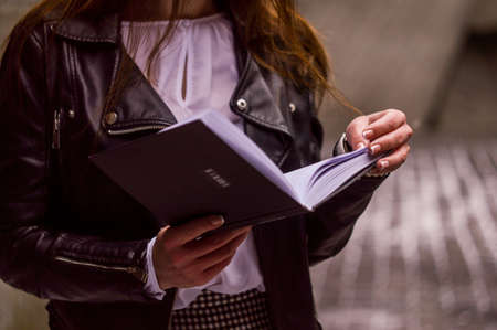 people, girl, female, woman, reading, book, knowledge, study, education, leather, jacket, clothing