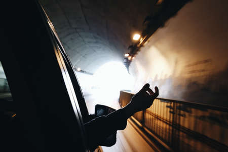 people, hand, tunnel, car, vehicle, transportation, dark, light