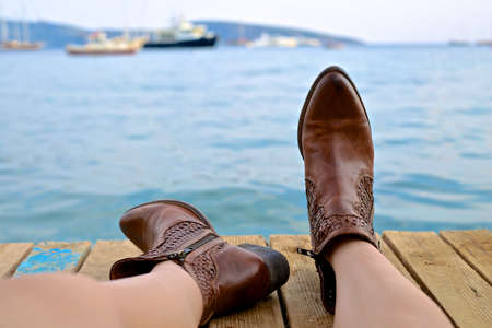 people, woman, boots, leather, brown, dock, wood, water, ocean, sea, boat, ship