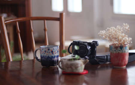 mug, cup, blur, table, chair, flower, display, camera, accessory, house, indoor, interior