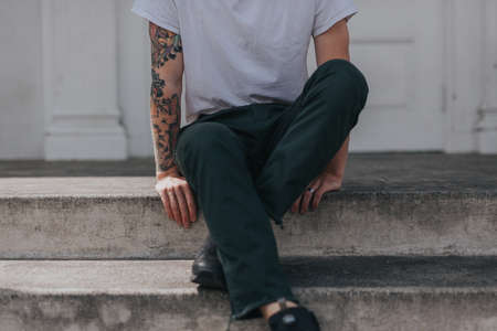 people, guy, man, sitting, alone, building, outside, tattoo