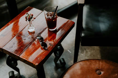 wooden, table, sunglasses, flower, vase, furniture, soda, drinks