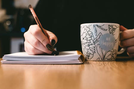 be happy,  cup,  coffee,  woman,  holding,  pen,  notepad,  writing,  notebook,  wood,  desk, ...