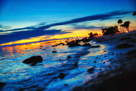 beach,  sunset,  dusk,  water sunset,  city lights,  beach close up,  sunset after glow