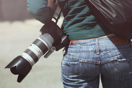 Person Carrying Black Dslr Camera