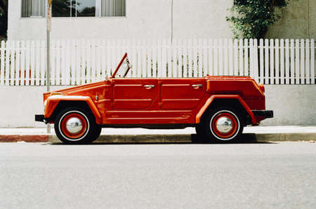 Vintage Red Coupe Parked Beside Gutter