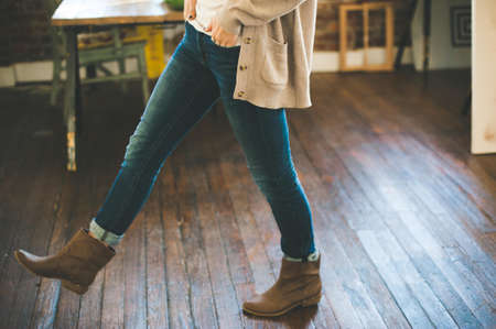 Woman Walking on Brown Parquet Floor