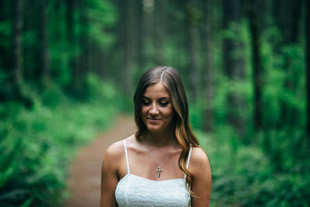 Focus Photography of Smiling Woman Wearing White Spaghetti Strap Top