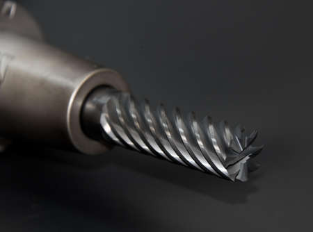 Silver Drill Bit on Gray Surface