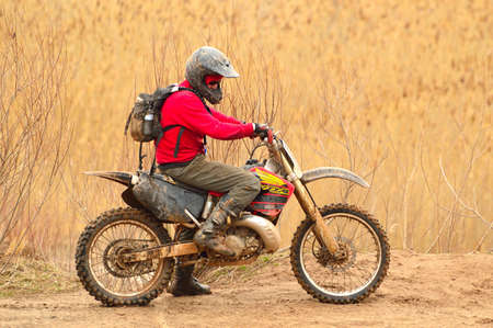 Man in Red Sweater Driving Dirt Bike