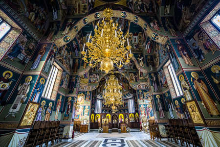 Gold Chandelier and Green Blue and White Wall