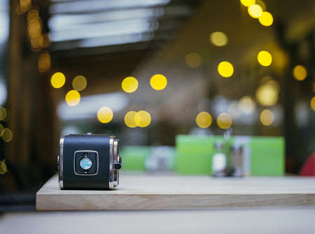 Selective Focus Photography of Black Case on Brown Wooden Surface