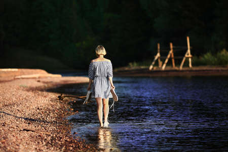 Woman Walking Near Body of Water