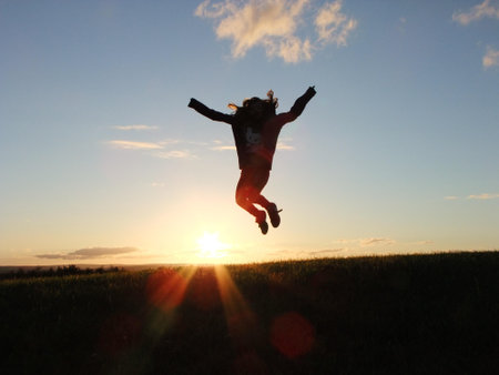 Silhouette Photo of a Person Jumping Nearby Green Grass Field during Golden Hour