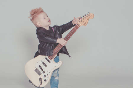Boy Wearing Black Jacket Holding Electric Guitar