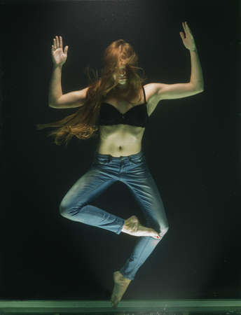 Woman Wearing Black Bra and Blue Denim Jeans Underwater