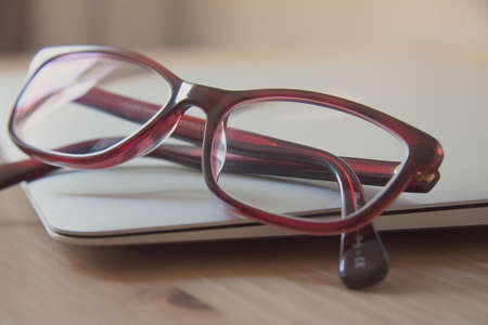 Eyeglasses With Red Frames on Laptop Computer