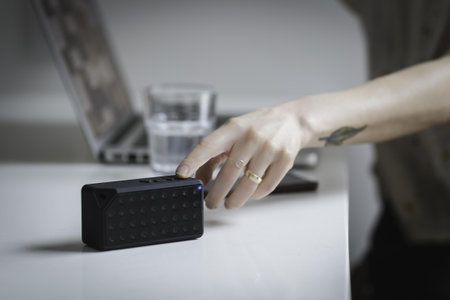 Rectangular Black Speaker on White Wooden Surface