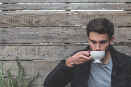 Man Holding Ceramic Teapot