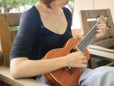 Woman Holding Brown Ukulele