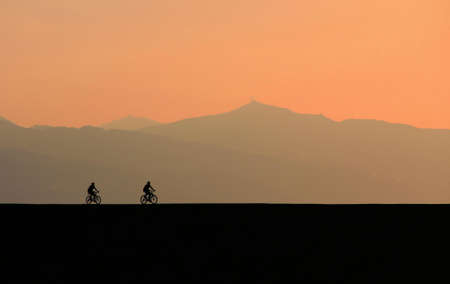 Silhouette Photo of Two Cyclists