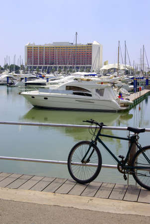 Luxurious yachts docked in marina near large hotelの写真素材