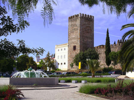 Medieval Castle and fountain in Portuguese village, with foliage frame.