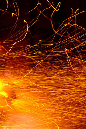 Photo of hot sparks dancing in a barbecue