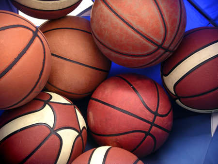 Photo of several oranje basket balls inside a blue bag.の写真素材