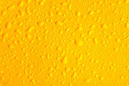 Pattern of water drops in a plastic yellow backgroundの写真素材