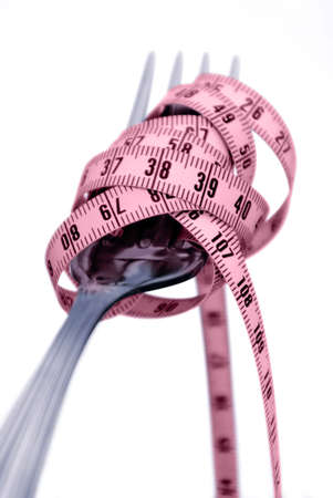 Concept photo of fork with measuring tape instead of spaghetti