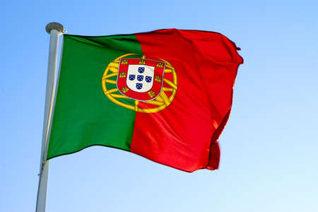 Portuguese national flag waving against a clear blue skyの写真素材