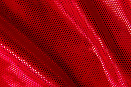 Red fabric background with shining little sequinsの写真素材