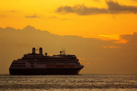Large cruise ship at sunrise in a journey into the horizonの写真素材