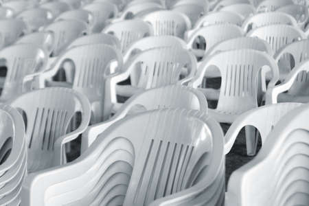 A large amount of empty white plastic chairsの写真素材