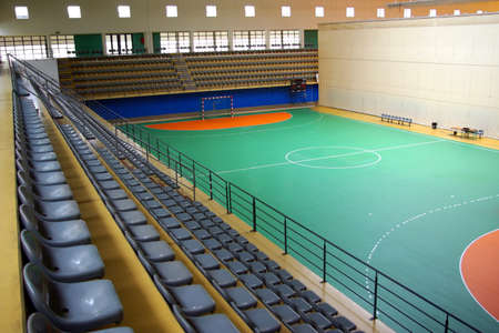 Indoor multi sports facility with empty gaming field and seatsの写真素材