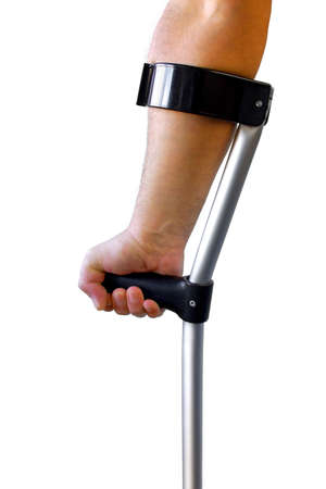 Male arm and hand holding a crutch isolated in whiteの写真素材