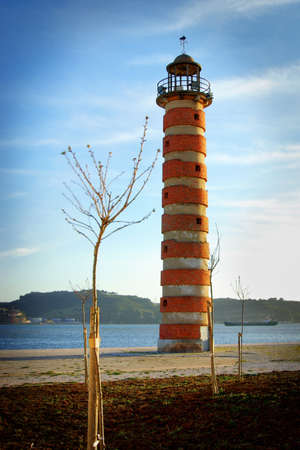Old deactivated lighthouse in Lisbon by the Tagus riverの写真素材