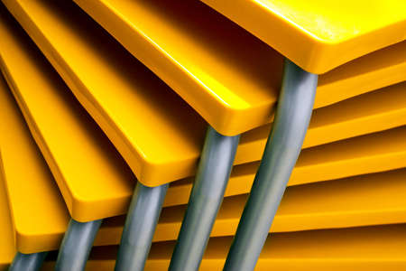 Pile of many yellow tables in the patio of a closed restaurantの写真素材