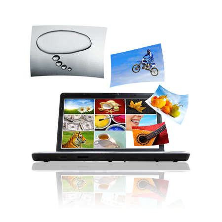 Compositions of photos detaching and flying over a laptopの写真素材