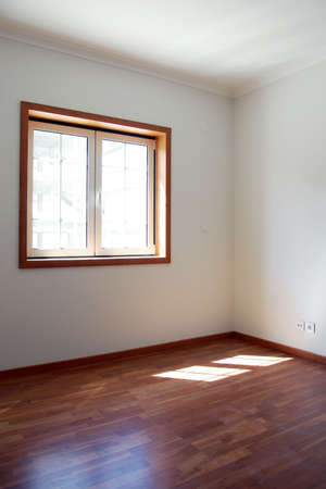 Empty room with a window and white walls in a new houseの写真素材