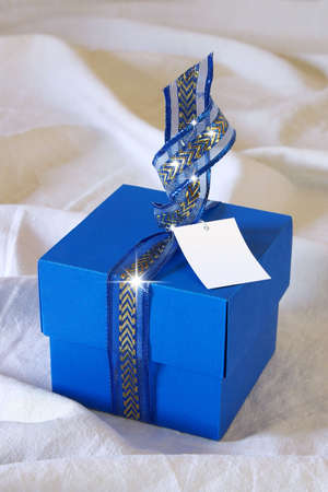 Blue gift box with Christmas decorations and spakling lightsの写真素材