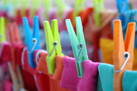 Close-up of colorful laundry pins and hanged clothes dryingの写真素材